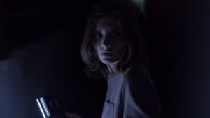 Impossible Horror Lily (Haley Walker) walks down a long dark tunnel
